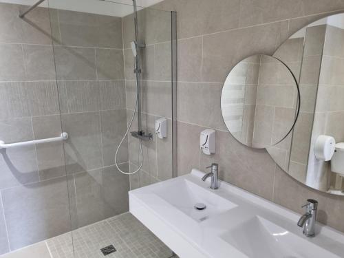 a bathroom with a shower and a sink and a mirror at Auberge des Salles in Les Salles-sur-Verdon