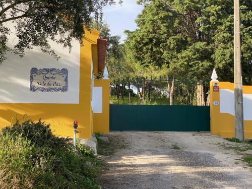 a yellow fence with a sign that reads chill wildlife at Quinta Vale da Paz in Azambuja