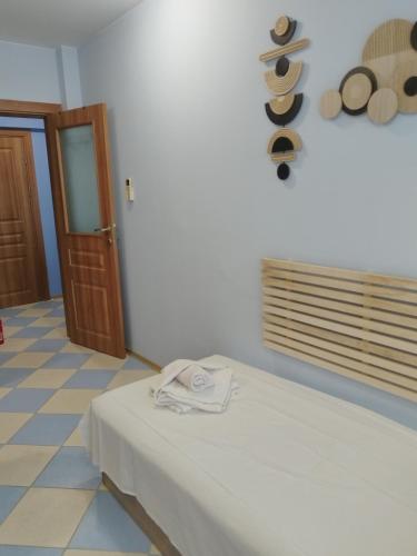 a room with a bed with a towel on it at Apartments Victoria in Kranevo