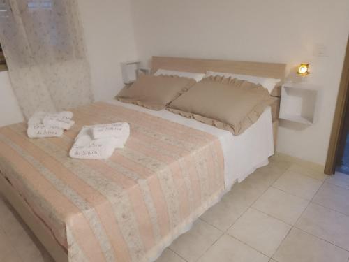 a bedroom with a bed with two pillows on it at Carpe Diem da Salvina in Pachino