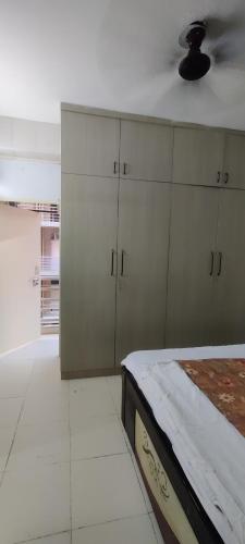 a bedroom with a bed and cabinets and a ceiling at Aesthetic abode in Sohna
