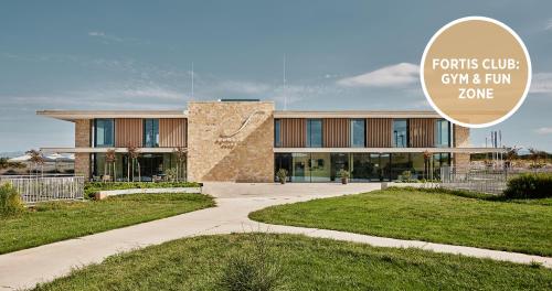 a building with a sign that reads forks cube gin and fun zone at Falkensteiner Family Hotel Diadora in Zadar
