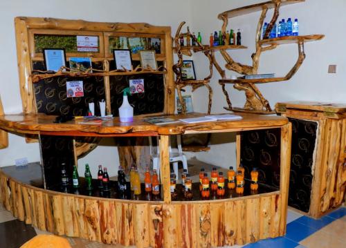 a bar filled with lots of bottles of alcohol at Enkapune Resort Naivasha in Naivasha
