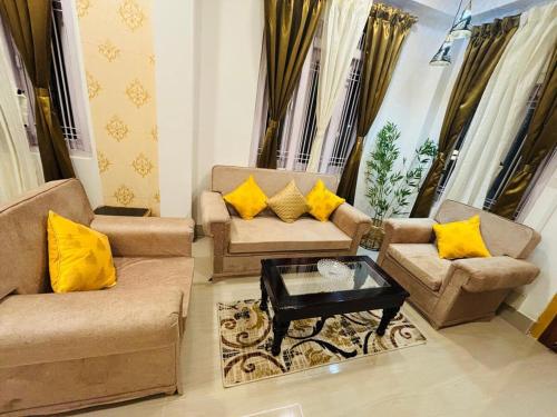 a living room with two couches and a coffee table at VANDYaS INN 1BHK Studio Unit in Guwahati