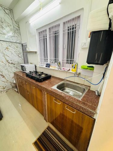 a kitchen with a sink and a counter top at VANDYaS INN 1BHK Studio Unit in Guwahati
