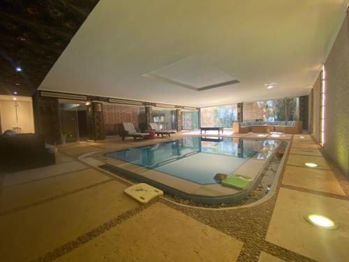 a large swimming pool in a house at One Sixteen Guest House in Sheikh Zayed