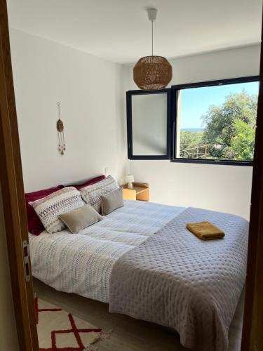 a bedroom with a bed and a large window at Casa di Cortanni in Castellare-di-Casinca