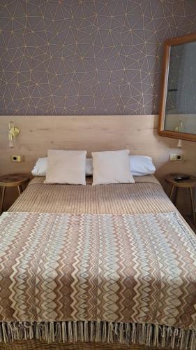 a bed in a room with two pillows on it at Etea-Vigo in Vigo