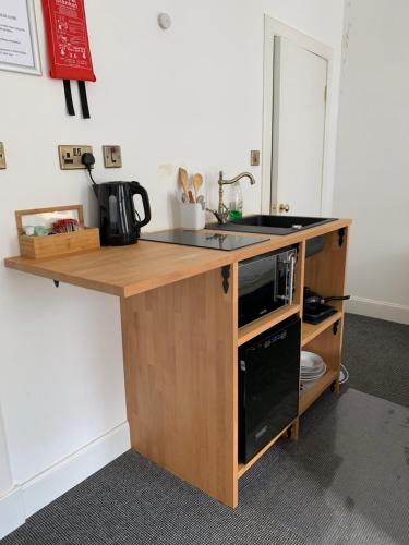 a kitchen counter with a sink and a microwave at Royal Mile Balconies by the Castle in Edinburgh