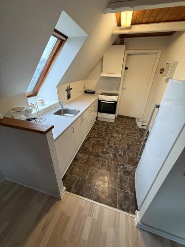 a large kitchen with a sink and a stove at Folsted Ferie lejlighed nr 1 in Bindslev