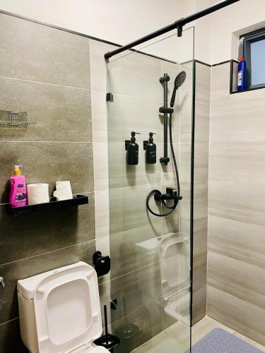 a bathroom with a shower stall with a toilet at Kozy Homes in Nairobi