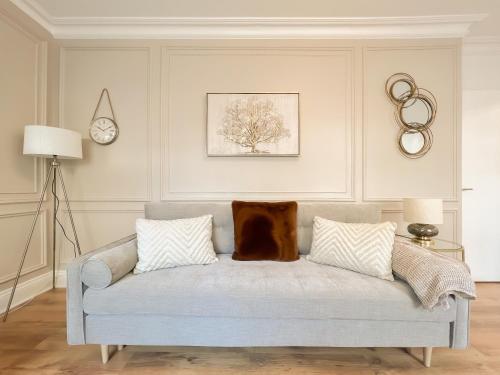 a living room with a couch with a dog sitting on it at Cozy 1 bed Blythswood Apartment in Glasgow