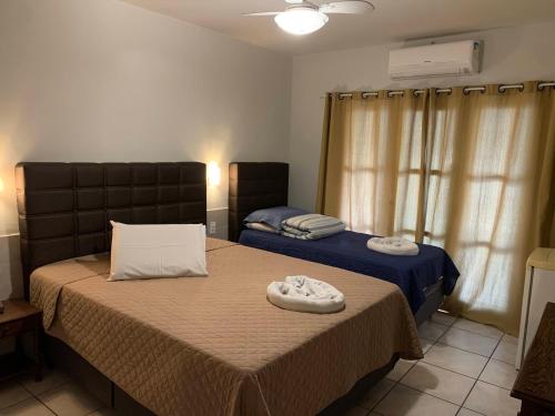 a bedroom with two beds with towels on them at Hotel Pierazzo in Santa Teresa