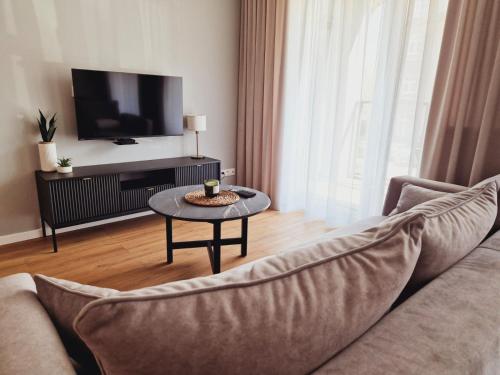 a living room with a couch and a table at Apartament Gniezno Bulwary 7a in Gniezno