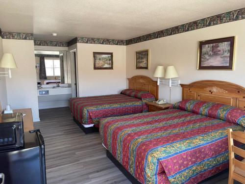 a hotel room with two beds and a bathroom at Lakeside inn & suites by OYO Mathis I 37 in Mathis
