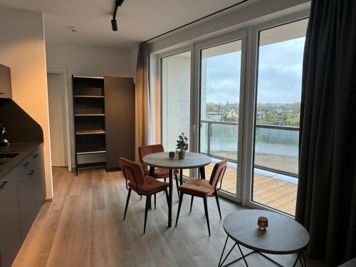 a kitchen with a table and chairs and a large window at Exklusives Wohnen im historischen Wasserturm dem Highlight von Delitzsch WE317 in Delitzsch