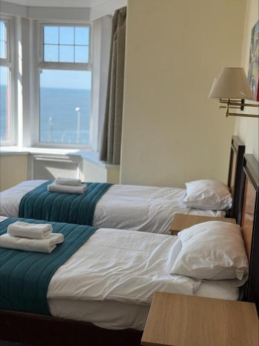 two beds sitting next to each other in a room at The Savoy Hotel in Blackpool