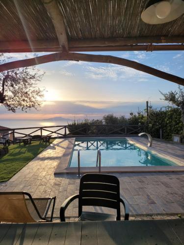 a view of a swimming pool with a table and chairs at Villa Bellatrix in Massa Lubrense