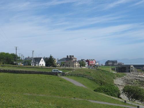 a grassy hill with a road and houses on it at Seacrest Guesthouse in Mullaghmore