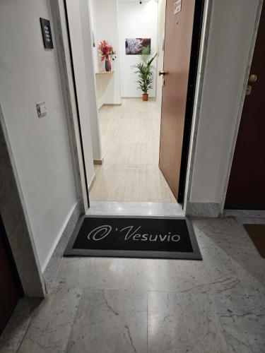 a hallway with a welcome mat on the floor at O' Vesuvio B & B in Torre del Greco