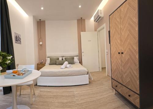 a bedroom with a bed and a table and a table at O' Vesuvio B & B in Torre del Greco