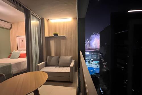 a room with a bed and a couch and a table at Apartamentos em frente ao Allianz Parque in Sao Paulo