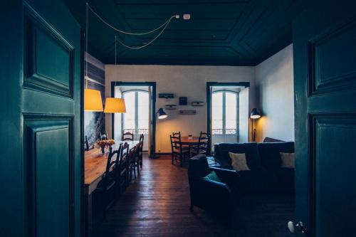 a living room with a couch and a dining room at Boutique Taghostel in Lagos