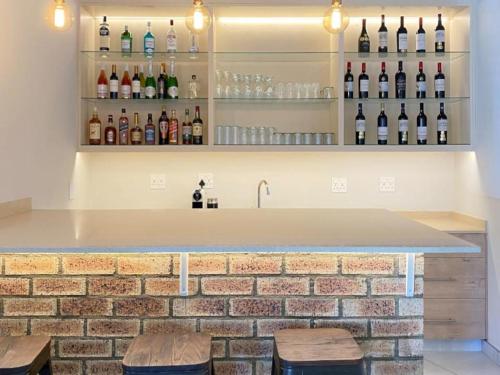 a bar with bottles of wine on the wall at The Grand Comfort in Rustenburg