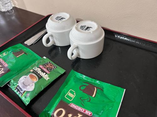 a table with two cups and two bags of oreos at Tekoma Resort Cameron Highlands in Tanah Rata