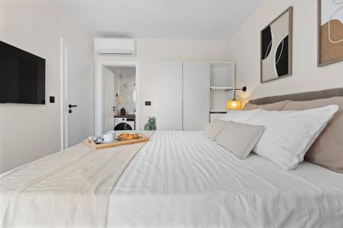 a large white bed with a tray of food on it at Charming Villa Harmonia with Heated pool and Indoor Jacuzzi surrounded by nature in Pićan