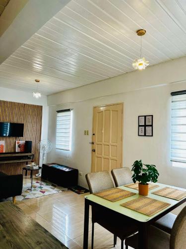 a living room with a table and a couch at Host Homes Camella Whole House- 3BR Cozy Townhouse in Campetic Palo in Palo