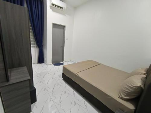 a bedroom with a bed and a tv in a room at AZ Homestay Meranti in Pasir Mas