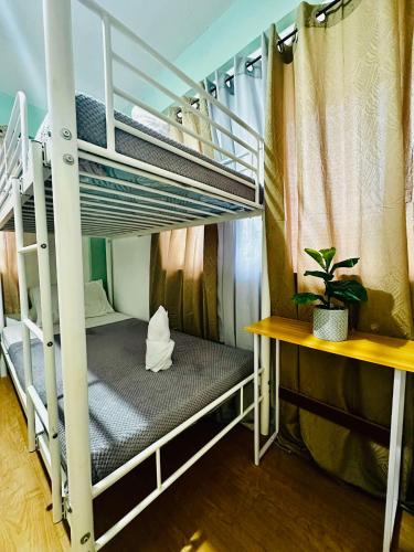 a room with two bunk beds and a desk at Host Homes Camella Whole House- 3BR Cozy Townhouse in Campetic Palo in Palo