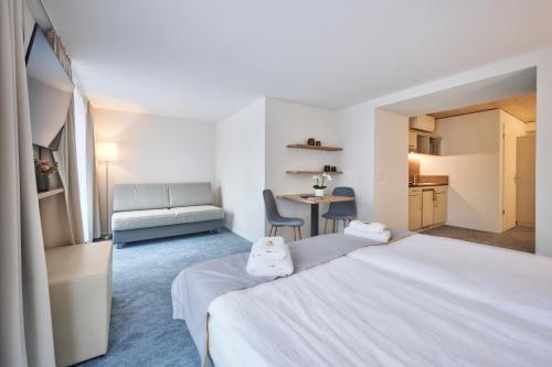 a hotel room with a bed and a table at Aparthotel Krone - Self Check-In in Interlaken