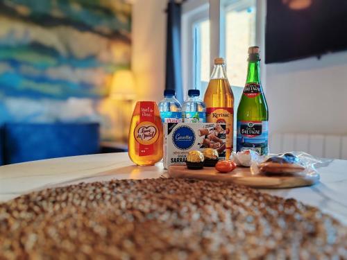 a table with bottles of alcohol and food and drinks at Ker Yuna & Spa in Dinan