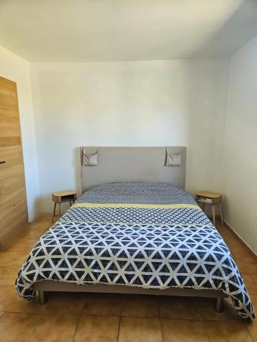 une chambre avec un lit avec une couette bleue et blanche dans l'établissement Villa climatisée avec piscine et aire de jeux enfants, à Pernes-les-Fontaines