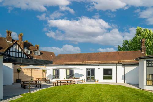 a courtyard with tables and chairs in a building at Holiday Inn London-Bexley by IHG in Bexley
