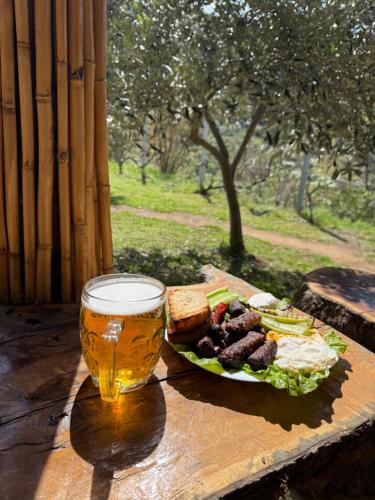 a plate of food and a glass of beer on a table at Baven -Toven Naturae in Rubik