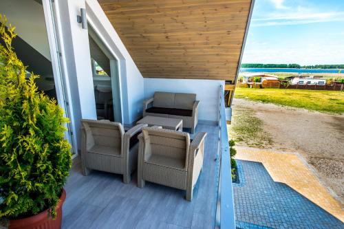 an outside view of a tiny house with chairs and a table at Aparthotel EuforiaPort in Pisz