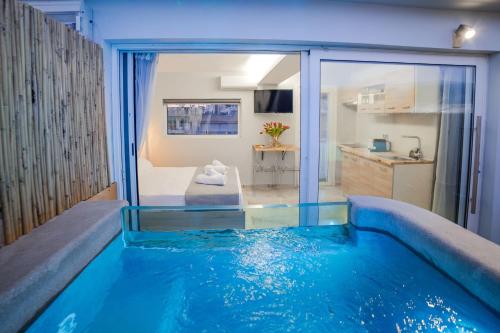 a house with a swimming pool in the middle of a room at Paradise Heated Jacuzzi with Acropolis View in Athens