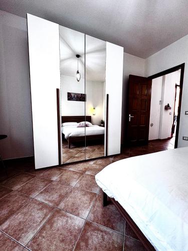 a bedroom with a bed and a large mirror at Casa Lia in Monastir
