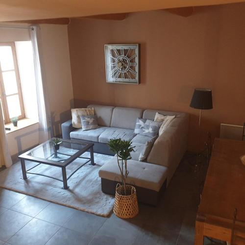 a living room with a couch and a table at Gîte de la Tour Carrée in Taulignan
