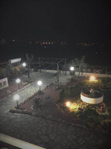 a courtyard at night with lights on the beach at A Casa di Amy in Macari