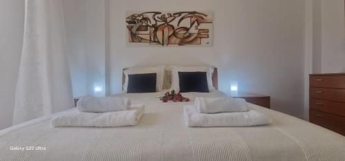 a large white bed with two pillows on it at Joana's room 1 in Lisbon