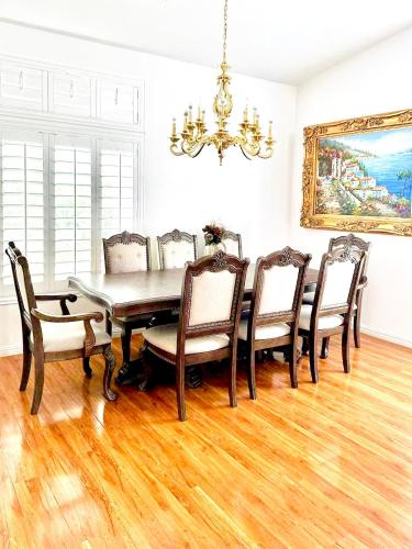 a dining room with a table and chairs and a chandelier at Private rooms in Las Vegas