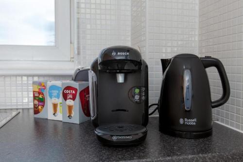 a coffee maker sitting on top of a counter at Super Prime Park View Duloch By Tba in Dunfermline