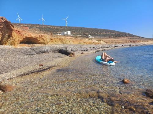 a person laying on a raft in the water on a beach at CasaEole in El Haouaria