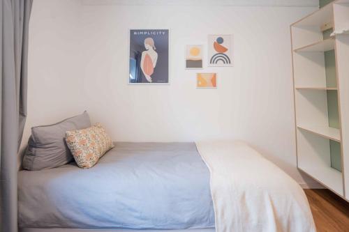 a small bedroom with a bed and a book shelf at FREYZEIT Apartments Speyer in Speyer