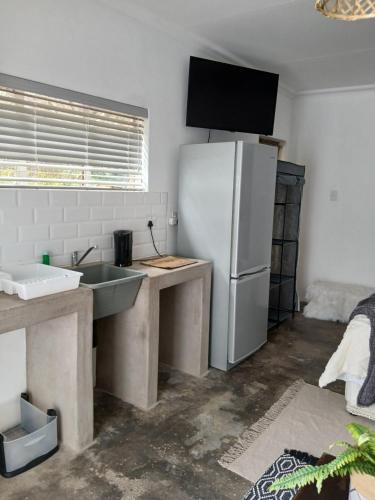 a kitchen with a white refrigerator and a sink at Karoo in Douglas