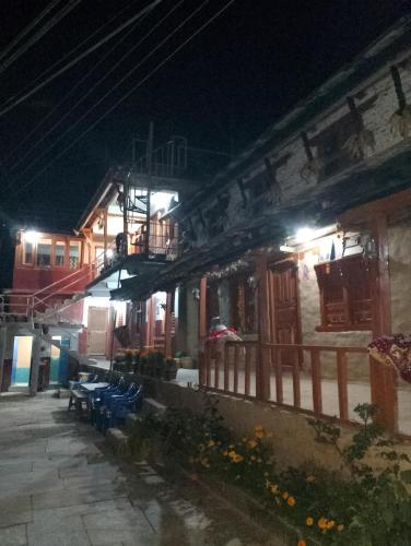 a group of buildings at night with lights at Ananya homestey in Astam